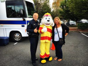 man officer thumbs up with dog costume person and woman