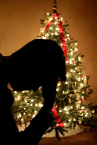 christmas tree lit up man silhouette stressed