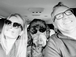 black and white photo woman man dog with sunglasses