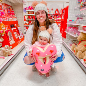 woman holding baby valentines aisle