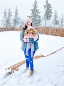 woman holding child in snow