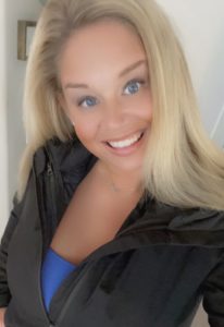 smiling blonde woman black jacket